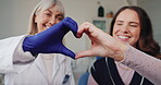 Woman, smile and hands as heart at dentist with happiness for healthcare, teeth whitening and dental service. Girl, face and love sign in clinic at orthodontist for trust, care or positive experience