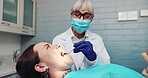 Oral care, dentist and looking with mirror at patient for healthcare, consultation and cavity inspection in practice. Woman, ppe and dental specialist with tools for examination, cleaning and filling