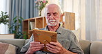 Senior, man and thinking with photograph on couch for reminiscing, nostalgia and remember memory of history or past. Elderly person, hug and sad on sofa with picture, missing and mourning in home.