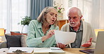 Senior couple, documents and financial crisis with laptop for debt, expenses or missed payment on bills at home. Elderly man and woman in argument with paperwork for receipt, cost or budget at house