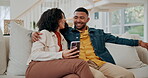 Black couple, phone and hug in home to relax, talking and scroll on social media together on sofa. Happy people, embrace and reading ebook together on weekend, texting and app for online application