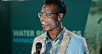 Presentation, speaker and black man with mic for water management workshop with resources. Seminar, talking and male presenter on podium at convention for agro sustainability research at event.