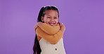 Hug, portrait and child in studio with self love, smile or identity development for happy kid. Care, empowerment and girl with positive attitude, affirmation or confident mindset on purple background