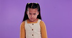 Angry, upset and face of child in studio with bad mood, attitude and behavior issue on purple background. Body language, emoji and portrait of young girl with frustrated, problem and frown in studio