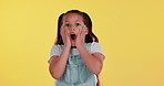 Shock, surprise and face of child in studio for news, announcement and information. Wow, emoji and portrait of young girl with reaction for candy store sale, deal and discount on yellow background