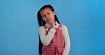 Little girl, thinking and idea with decision for choice, option or pick in studio on a blue background. Young female person, child or kid in wonder, thought or memory for solution, unsure or remember