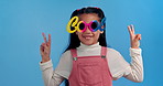 Peace sign, sunglasses and face of child in studio for confidence, trendy style and cool accessories. Happy, fashion and portrait of girl with eyewear for emoji, pride and cute on blue background