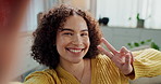 Girl, selfie and happy with peace sign in home for growth, audience or face on social media in living room. Woman, person and influencer with kiss, emoji and tongue out for portrait on live stream