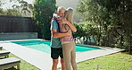 ​​Mature couple, hug and love in backyard for fitness, wellness and workout break, support or care at home. Happy man and woman embrace by outdoor pool or garden for holiday activity, pilates or yoga