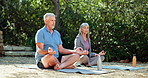 Senior couple, yoga and morning on grass with high five, smile and happy with teamwork in summer. Retirement, woman and man with mat on lawn in backyard at house for meditation with water in sunshine