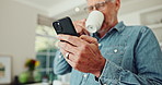 Smartphone, coffee and mature man in kitchen with pride for stock investment profit with online bank app. Happy, phone and senior person drink cappuccino and reading news blog on internet at home.