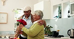 Senior couple, happy and roses in home for love, gift and romance in marriage. Elderly people, flower bouquet and hug in kitchen for birthday, celebrating milestone and commitment in relationship