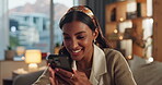 Home, excited and woman using phone on sofa for online relationship, profile match or chat with partner. Indian girl, connection and reading on mobile app, dating website or what as reaction on couch