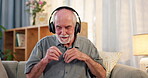 Senior man, sofa and dancing with headphone for music playlist and smile for entertainment. Nostalgic, lounge and couch on wireless earphones for streaming platform with song or album and home 