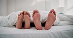 Sleep, feet or couple in bed for love, intimacy or relax on weekend in hotel room. Honeymoon, people or tired in bedroom for dreaming, romance or resting with partner for trust, commitment or comfort