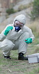 Test tube, drugs and person with box in nature for illegal development, experiment and sample. Meth, scientist and investigation with ppe in forest for opioid, manufacturing and chemical production