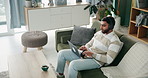 Relax, man and laptop with headphones on sofa for streaming music video, podcast or movie on social media. Male person, rest and digital earphones for film audio, entertainment and lounge at house

