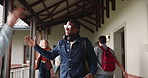 University, people and talking with handshake for education, greeting and learning for knowledge of study in hallway. Smile, men and students with fist bump for conversation, walking and classroom