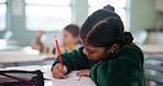 Girl, thinking and classroom for education at school with learning, knowledge and answers for information of exam. Student, writing and paper for lesson, assessment and creative notes for curriculum