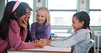 Student, friends and girl in school, talking and asking of assignment for homework and table. Classroom, happy and education for child, desk and chat for knowledge, learning and helping with project