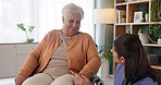 Senior care, nurse and old woman with wheelchair for advice, consultation and smile in nursing home. Living room, caregiver and elderly person with disability, homecare and support for retirement