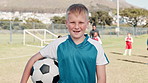 Boy, face and happy at training, soccer and ball with pride, learning and outdoor for development. Child, excited and football team in portrait, exercise and smile for sport, fitness and grass field