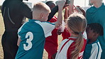 Coach, children and hands stack for soccer, motivation and game for sport with diversity on field. Man, football and teamwork in scrum for support, synergy or link with cheers for solidarity on pitch