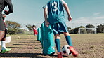 Boy, ball and practice for football on field with coaching, kick and instructor with training or motivation. Soccer club, child or running for workout, drill or player on grass for sport and exercise