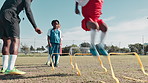 Soccer, sports and children jump for training, practice workout and exercise for playing match. Fitness, coach and kids learning with equipment on grass field for games, competition and tournament