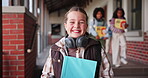 Face, girl and learner with book in outdoor for learning, education and development as student in school. Female child, headphones and smile for growth, skills and scholarship in literacy or numeracy