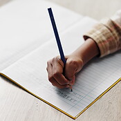 Letters, child and hand on desk, writing and closeup of education ...
