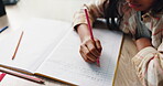 Alphabet, child and hand on desk, pencil and closeup of education, notebook and student in middle school. Classroom, studying and practice for exam, growth and development of kid, letters and table