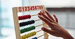 Math, child and hand on desk, abacus beads and closeup of education and student in middle school. Classroom, studying and practice for exam of counting, growth and development of kid on table