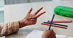 Counting, child and hand on desk, writing and closeup of education, notebook and student in middle school. Classroom, studying and practice for exam of maths, growth and development of kid on table