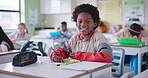 African boy, face and student in classroom with creative learning, skills development or coloring for school activity at desk. Portrait of smart, intelligent and confident or happy child in education