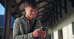 Boy, typing and happy on smartphone in high school, communication and gen z student laughing for online meme. Social media, texting and smile for education website results, connection and mobile app