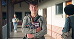 Happy, boy and face of student on high school with biology book for learning, growth and development for study. Male learner, portrait and textbook on campus for knowledge, bioscience and education.