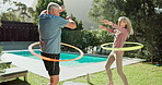 Training, hula hoop and senior couple in garden with high five for workout, achievement or retirement health. Wellness, happy man and elderly woman for exercise, fitness or hip mobility in backyard