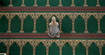 Carpet, prayer and woman in mosque for spiritual worship, praise and Islamic religion from above. Culture, respect and Muslim girl on floor with gratitude, morning dua and holy faith in meditation