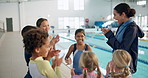 Cheering, children in huddle and swimming instructor woman in gymnasium for celebration or motivation. Applause, milestone and team building with coach clapping for kids at indoor pool of school