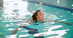 Woman, swimming and exercise in pool for health with aquatic sports, wellness and competition practice. African swimmer, cardio workout and training for triathlon, race event and performance in water