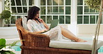 Resort, relax and woman with laptop, thinking and typing with ideas, research for novel and planning. Person, creative and writer with computer, brainstorming and review for article, journal and edit