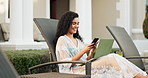 Laptop, phone and smile with woman at hotel for accommodation or hospitality on holiday. Computer, mobile and relax with happy tourist outdoor at luxury lodge or resort for travel and vacation