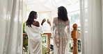 Back view, friends and cheers in hotel for holiday, vacation and luxury treatment in resort. Women, toast and hospitality on balcony for peace, relax and wellness on tropical island terrace in Bali