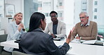 Meeting, diverse group and woman speaker in office for financial planning, budget and strategy for company growth. Female leader, proposal and talking at table for presentation, ideas and feedback