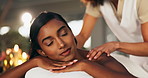 Spa, masseuse and women with back massage on table for holistic, healing and luxury hospitality service. Relax, female client and zen with self care treatment, satisfaction and health benefits