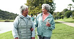 Fitness, walking and senior women in park outdoors together for bonding, exercise and relax in nature. Retirement, happy and mature people in conversation for wellness, health and active lifestyle