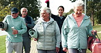 Fitness, walking and senior people in park outdoors together for bonding, yoga and relax in nature. Retirement, happy and men and women in conversation for wellness, health and pilates with trainer