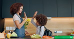 Mother, child and high five with backpack in morning, lunch or preparation to school at home. Mom helping son, kid or little boy getting ready for kindergarden with bag, food or healthy meal at house