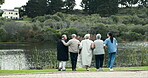 Back lake or retirement with nurse and old people outdoor together for activity or view. Assisted living, community and  senior group of friends in garden with happy caregiver for medical wellness